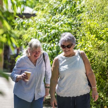 Two Older Ladies Laughing As They Walk Through The Zoo
