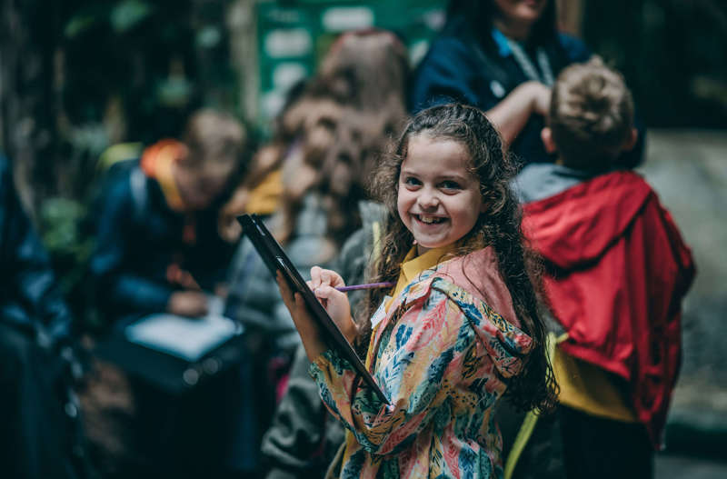 Young Girl On School Trip Holding Clipboard (1)